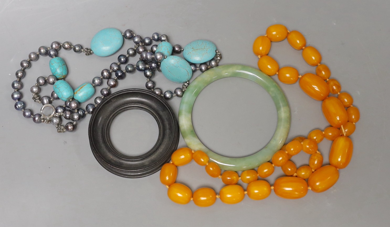 Mixed items including a pair of agate book ends, a simulated amber necklace, a turquoise necklace etc.